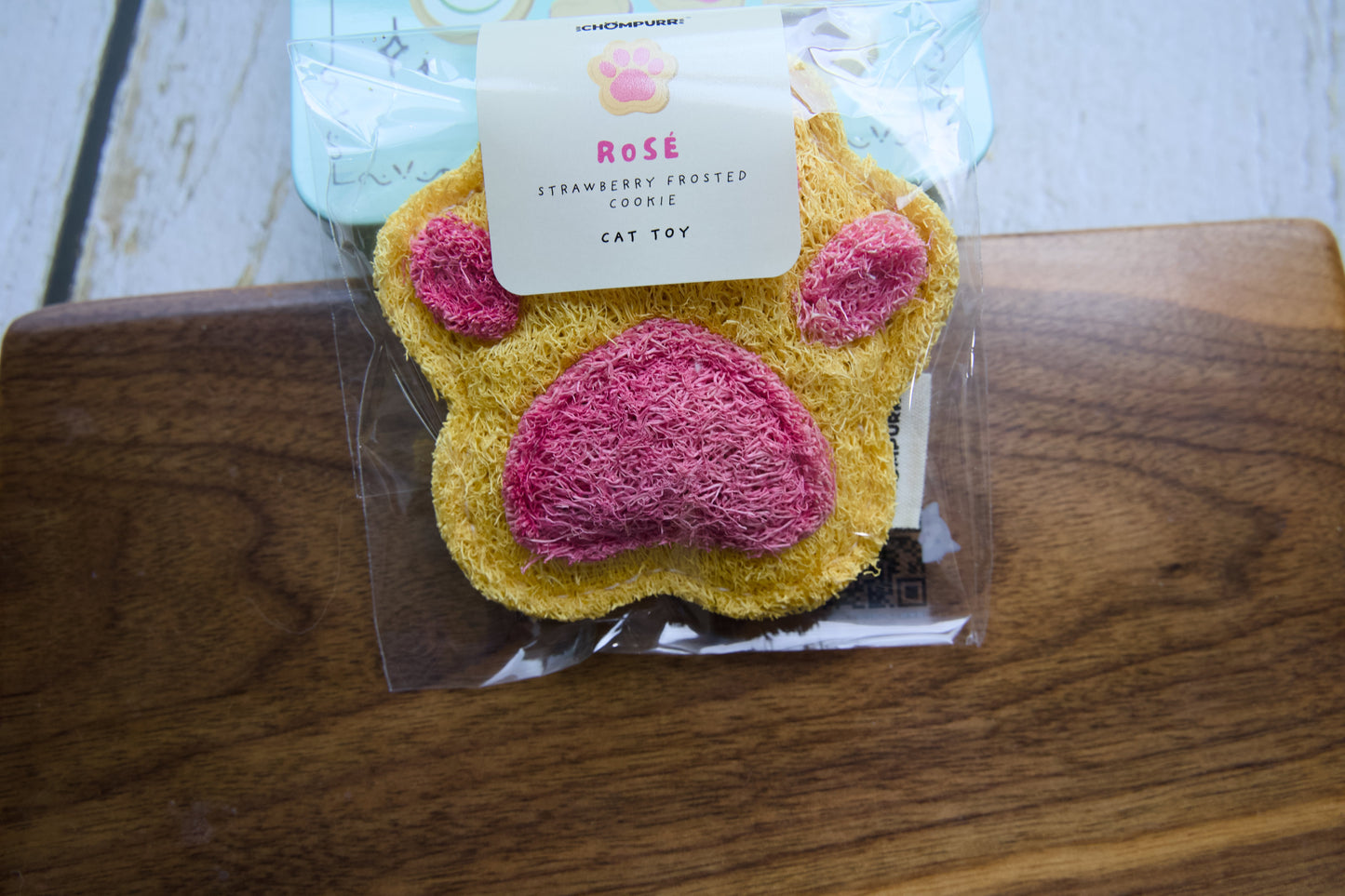 Close-up of the pink paw-shaped biscuit cat chew toy made of silvervine.