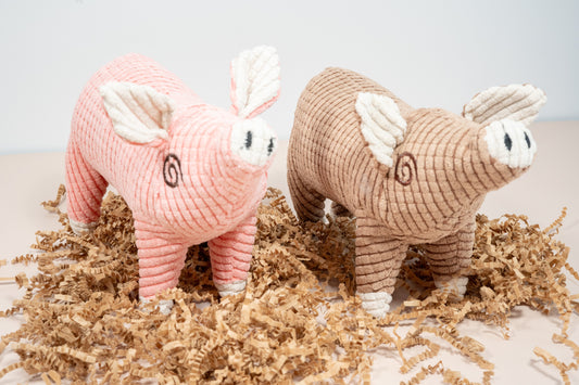 Two plush dog toys in the shape of a pig. | Deux peluches pour chien en forme de cochon.