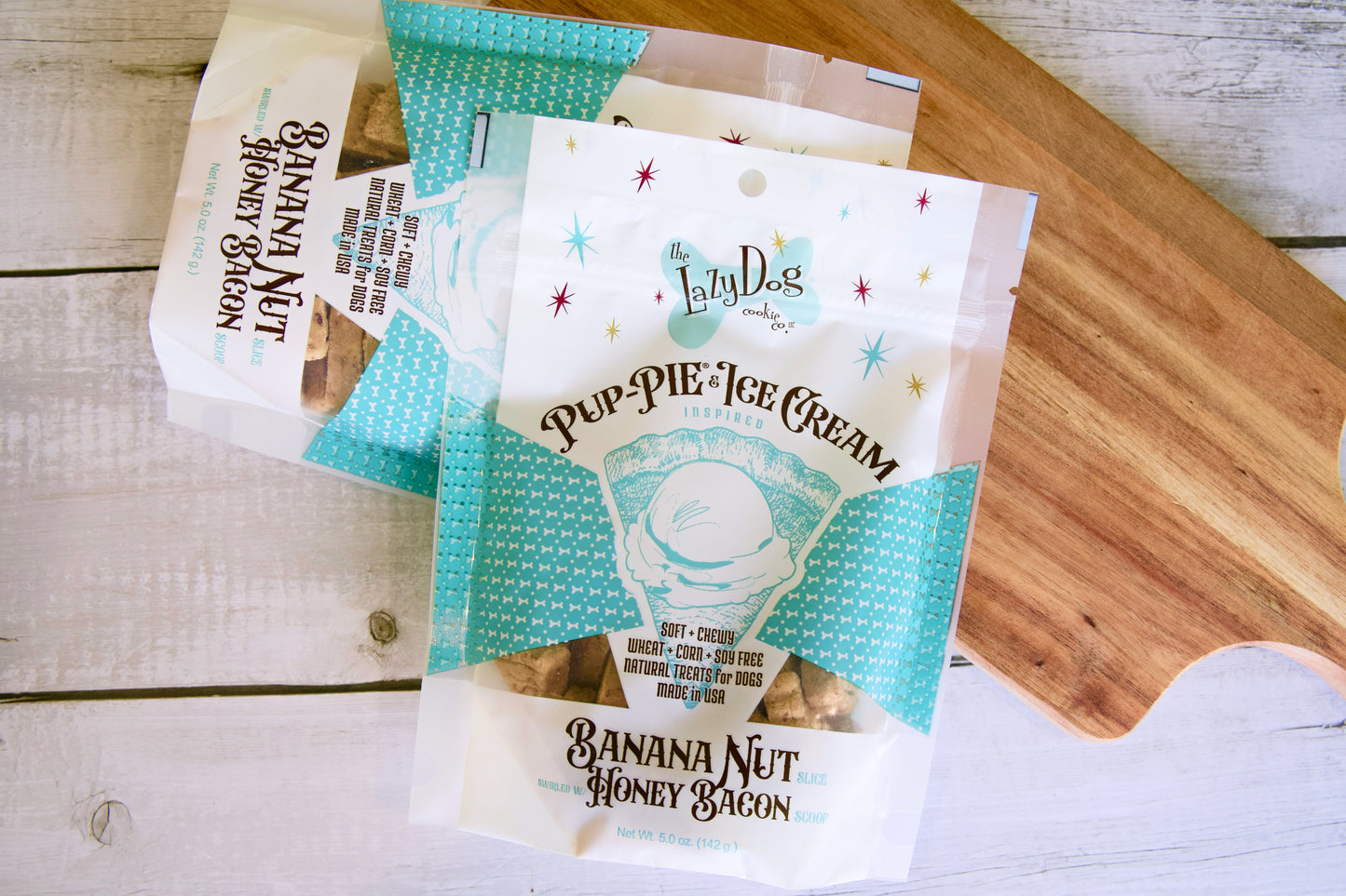 Friandises pour chien : glace, banane-noix et bacon au miel sur une surface en bois.