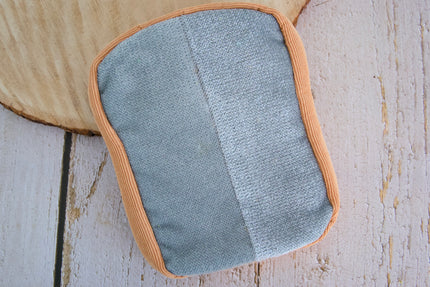 Toast-shaped Butter Mitten grooming accessory designed to remove pet hair from household surfaces and keep your home cleaner.