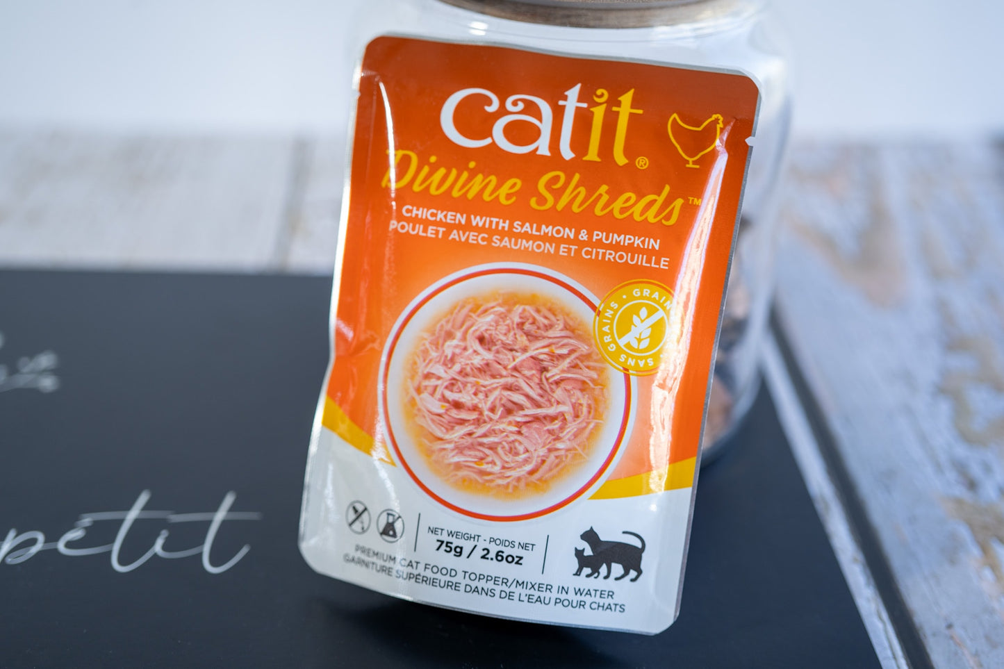 Premium cat food topping in water with chicken, salmon and pumpkin flavor.
