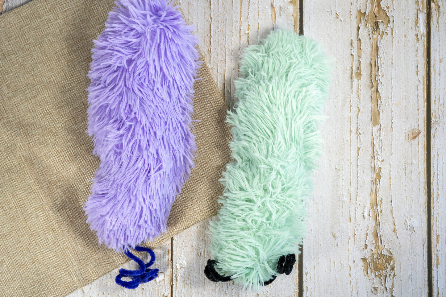 Plush cat toy in the shape of a giant caterpillar in pastel colors and long hair filled with catnip.