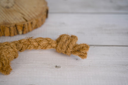 Jouet pour chien en corde de coco sur une surface en bois.
