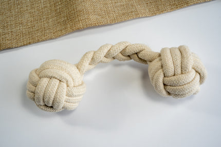 Cotton rope dog toy with monkey fists at the ends.