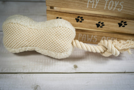 Peluche pour chien en forme d'os tridimensionnelle à 2 textures et avec corde à l'extrémité.