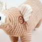 Close-up view of brown pig plush dog toy.