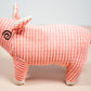 Side view pink pig shaped plush dog toy.