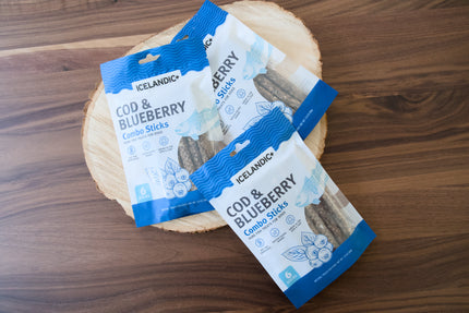 A close-up of a bag of natural dog treats made with cod and blueberries.