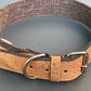 Dog collar with cork strap and metal buckle on a gray background.