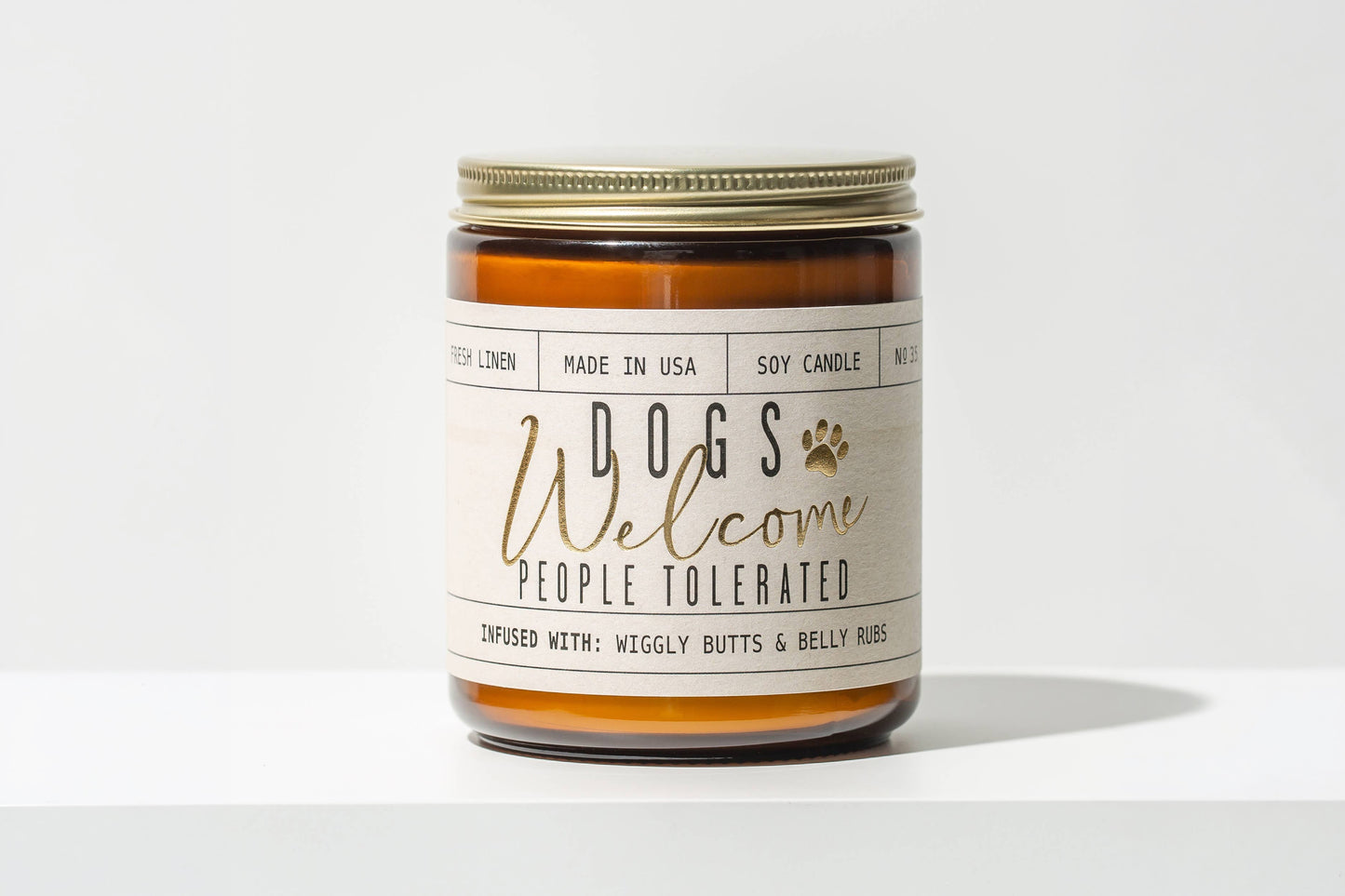 Pet-themed candle jar with DOGS Welcome PEOPLE TOLERATED text on a white background.