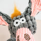Close-up view of donkey plush face with rope neck.