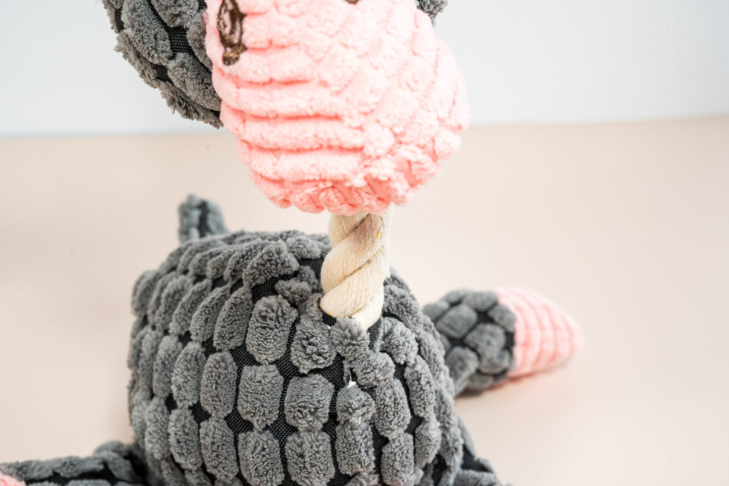 Close-up view of the rope neck of the donkey-shaped dog plush.