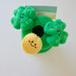 Top view of the leprechaun's hat dog plush toy with clover designs on a white background.