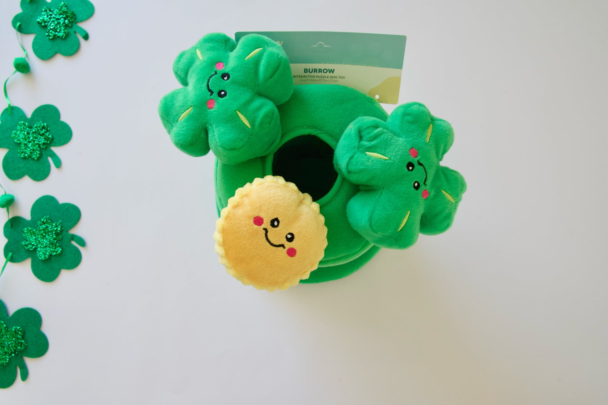 Top view of the leprechaun's hat dog plush toy with clover designs on a white background.