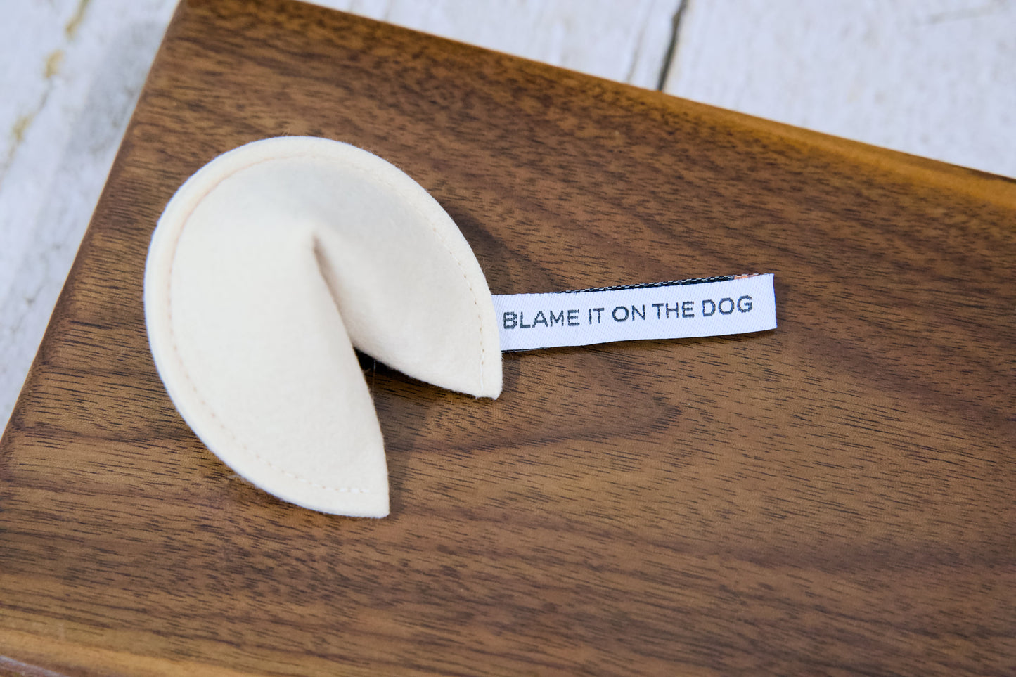 A fortune cookie cat toy with catnip and a tag that reads BLAME IT ON THE DOG.