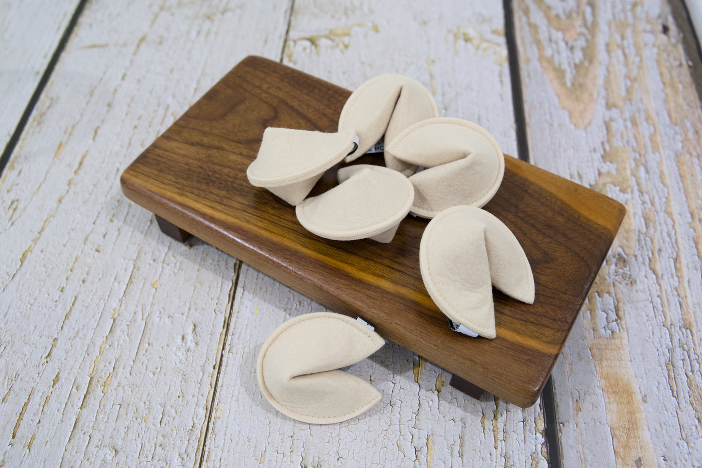 Several felt cat toys shaped like fortune cookies.