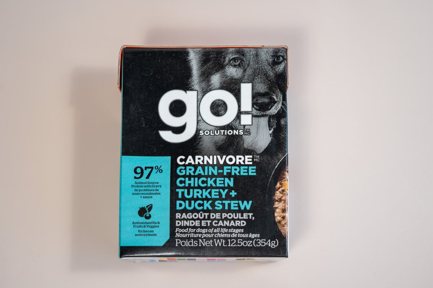 Chicken, turkey and duck stew food for dogs of all life stages with 97% animal source protein with gravy and antioxidant rich fruits and veggies.