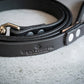 Black leather pet leash with company name printed.