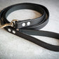 Uncoiled handmade black leather dog leash.