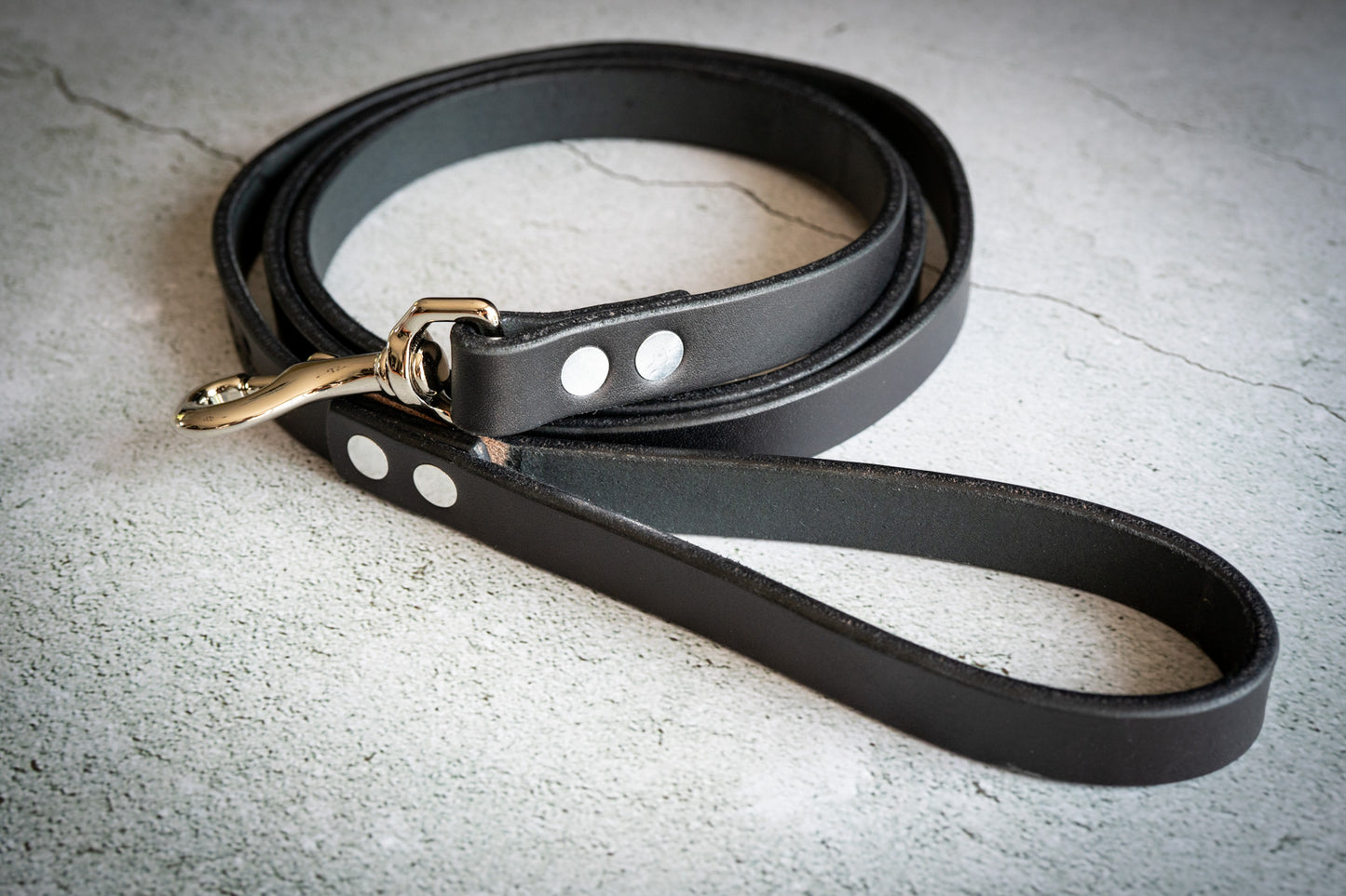 Uncoiled handmade black leather dog leash.