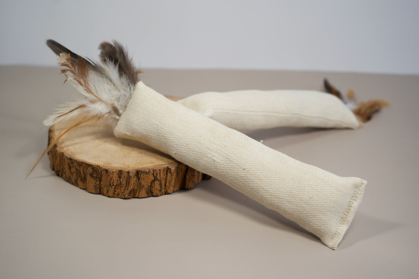 Natural cat kicker toy made with hemp fabric and natural feathers.