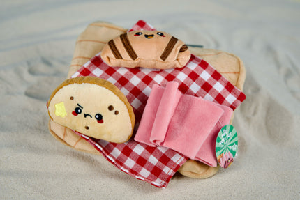 Interactive charcuterie board dog toy with squeaky bread, croissant and treat-hiding spots for mental stimulation