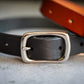 Close-up view of the nickel plated brass buckle of the black leather 3/4 inch dog collar.