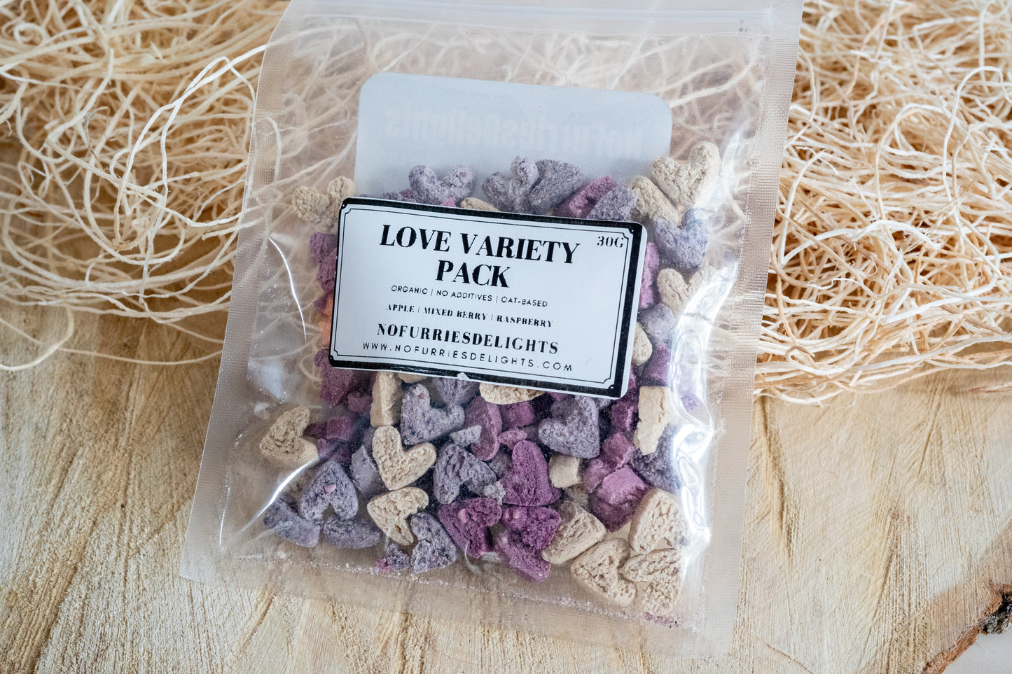 Love variety pack is heart shaped bites made with apples, mixed berries and raspberries for small pets and birds.