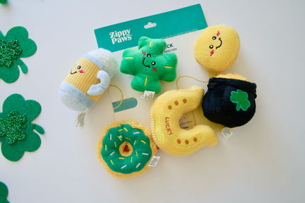 Plush dog toys with cartoon faces on a white background, featuring brand Zippy Paws.