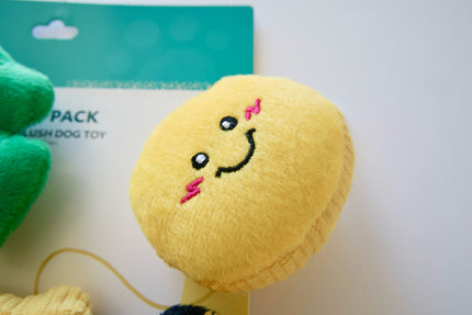 Yellow plush dog toy with a happy face design on a white background.