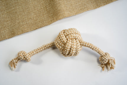 Monkey fist ball for dogs made of cotton rope and sisal with knots at the ends.