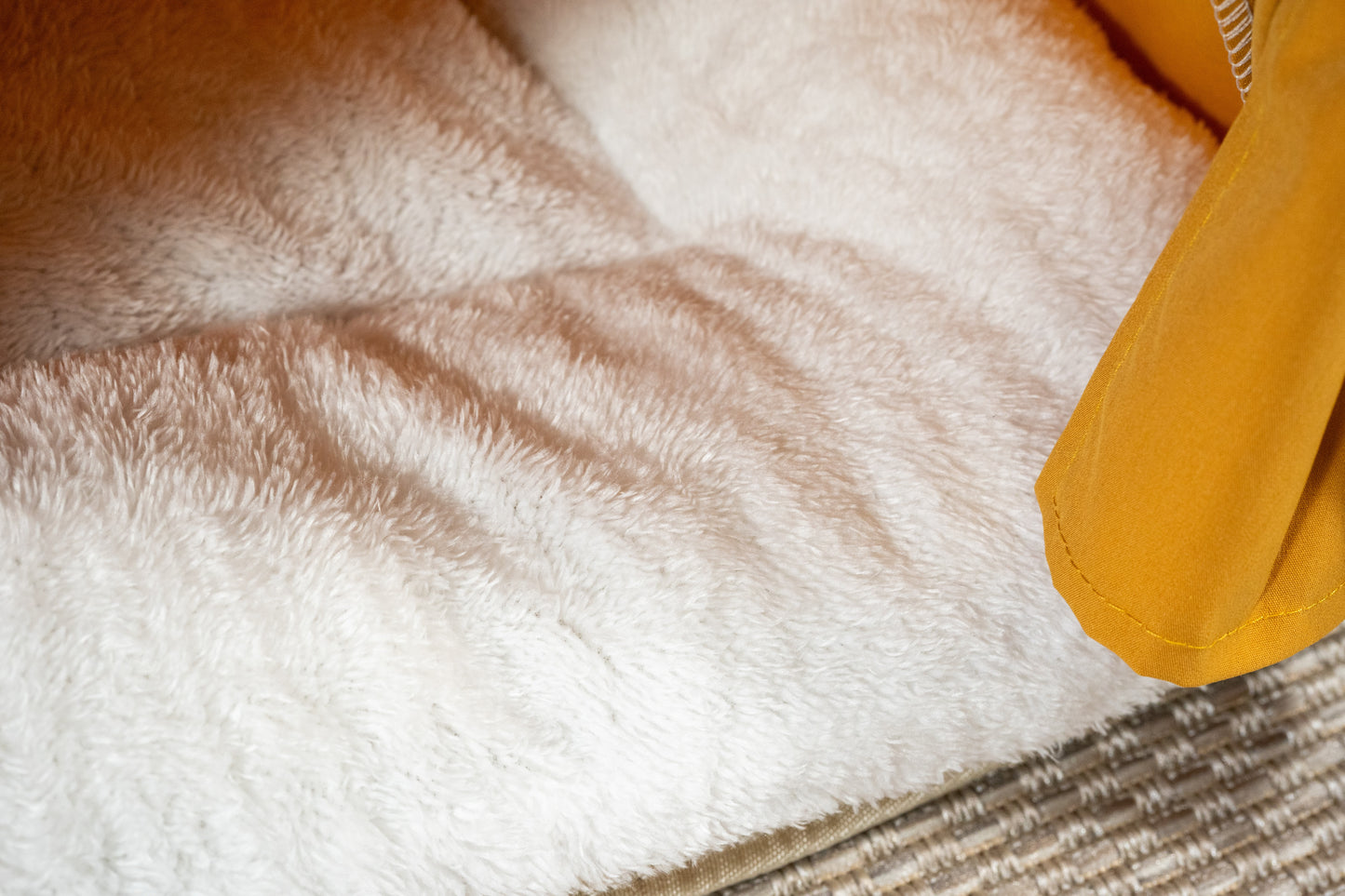 Vue rapprochée du coussin blanc de la tente orange super confortable et douce pour animaux.