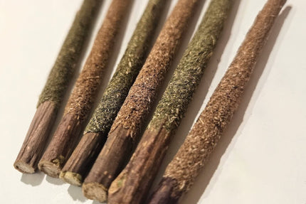 Close-up of silvervine sticks coated in silvervine powder and catnip.