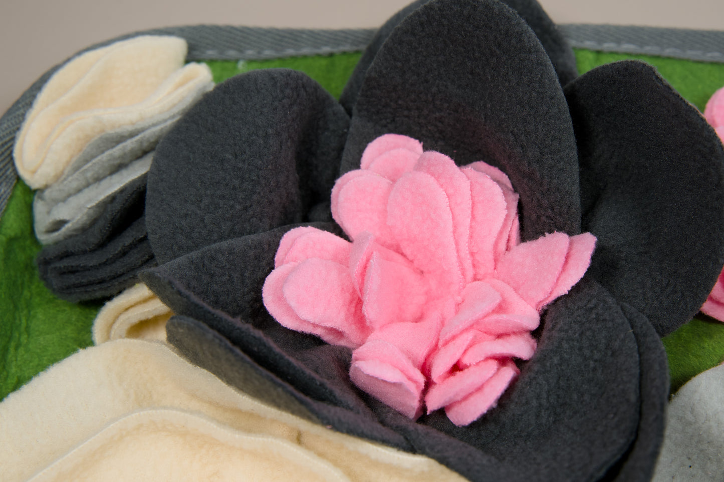 Enlarged view of a grey flower of the pet food mat.