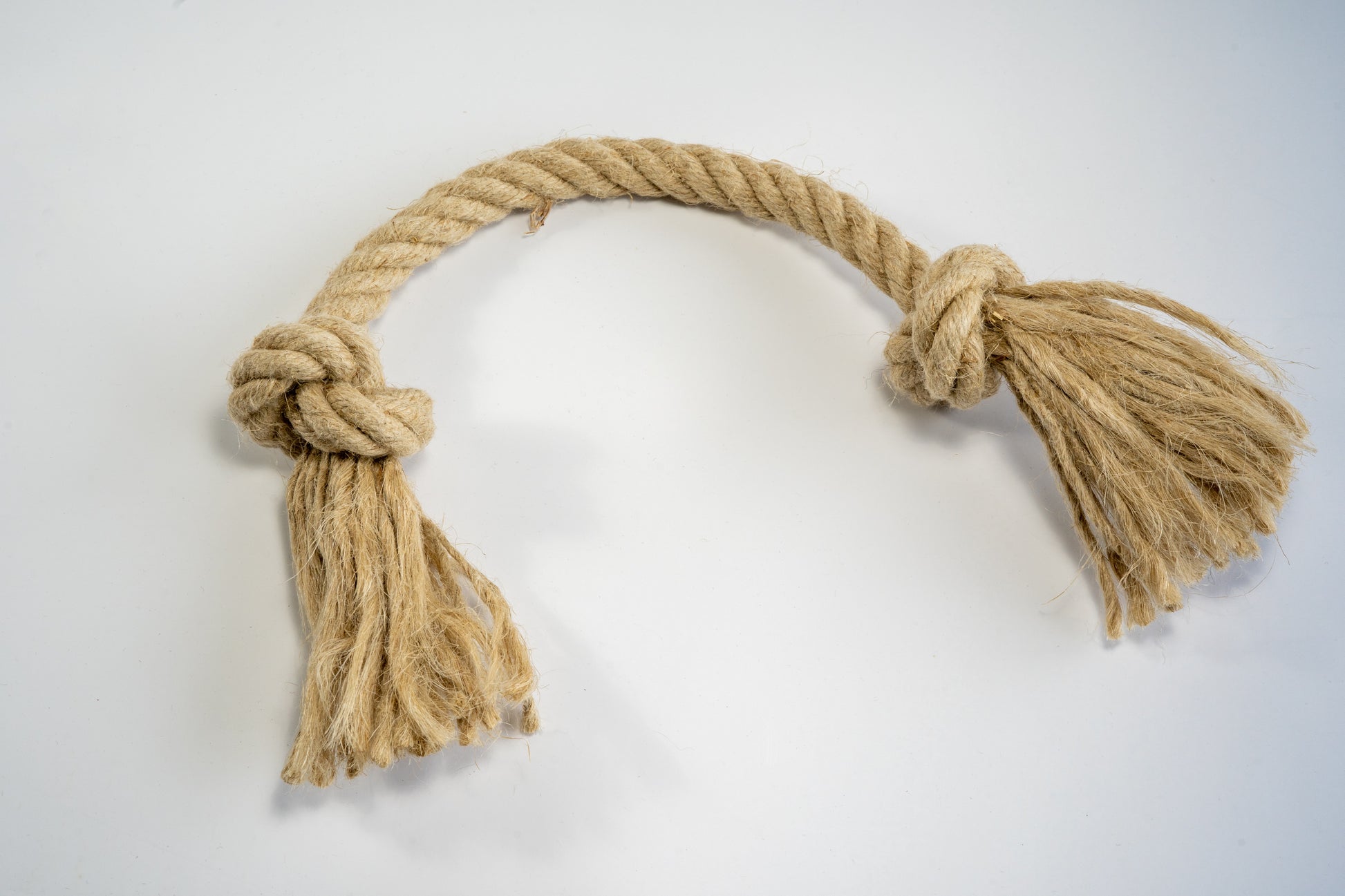 Medium toy for dogs made from hemp rope with knots at the ends. | Jouet de taille moyenne pour chiens en corde de chanvre avec noeuds aux bouts.