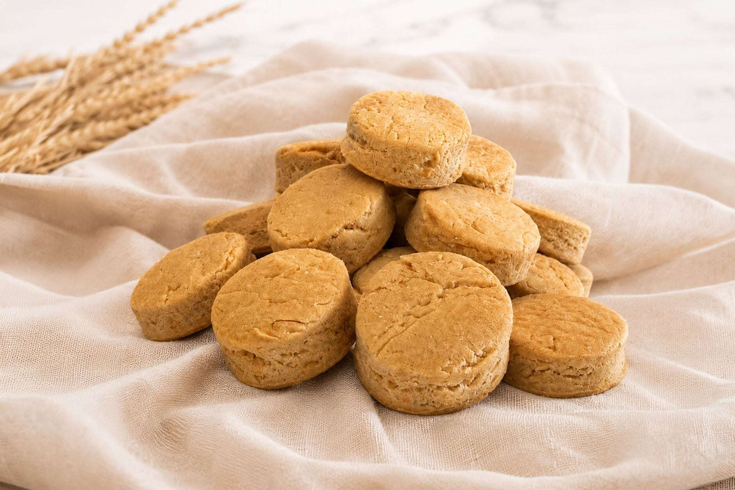 Close-up of Baxter Bailey Southern Cheese Biscuits, handcrafted gluten-free dog treats made with wholesome ingredients and aged parmesan cheese.