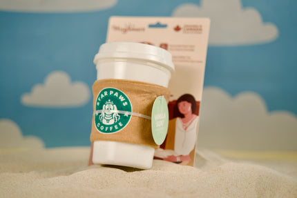 Coffee Time dog toy resting on a sunny sandbank, ready for beachside play.