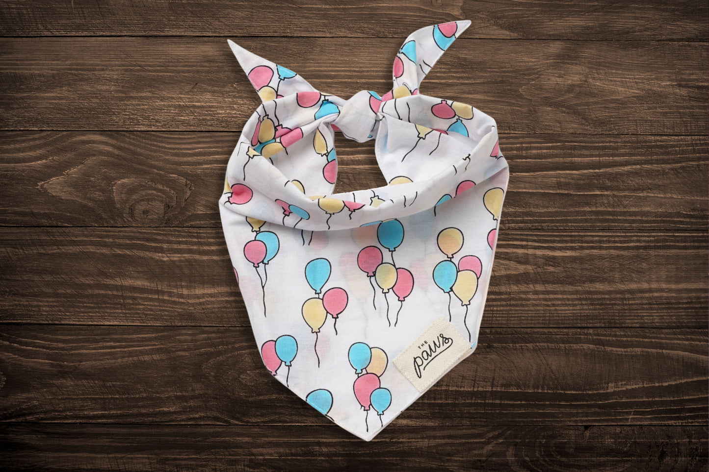 The Paws pet bandanas with party balloon designs.