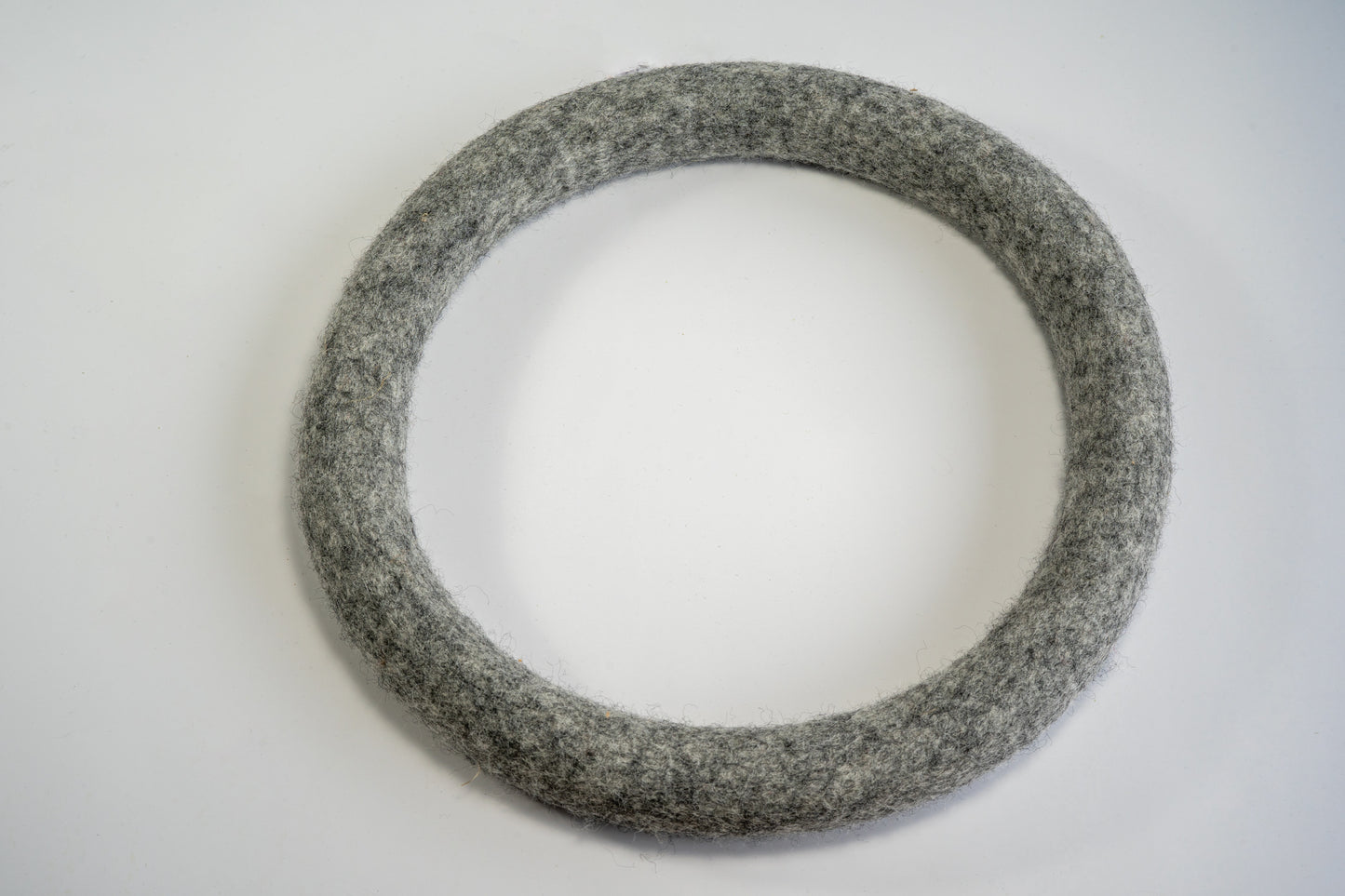 Large dark gray wool frisbee ring for dogs.