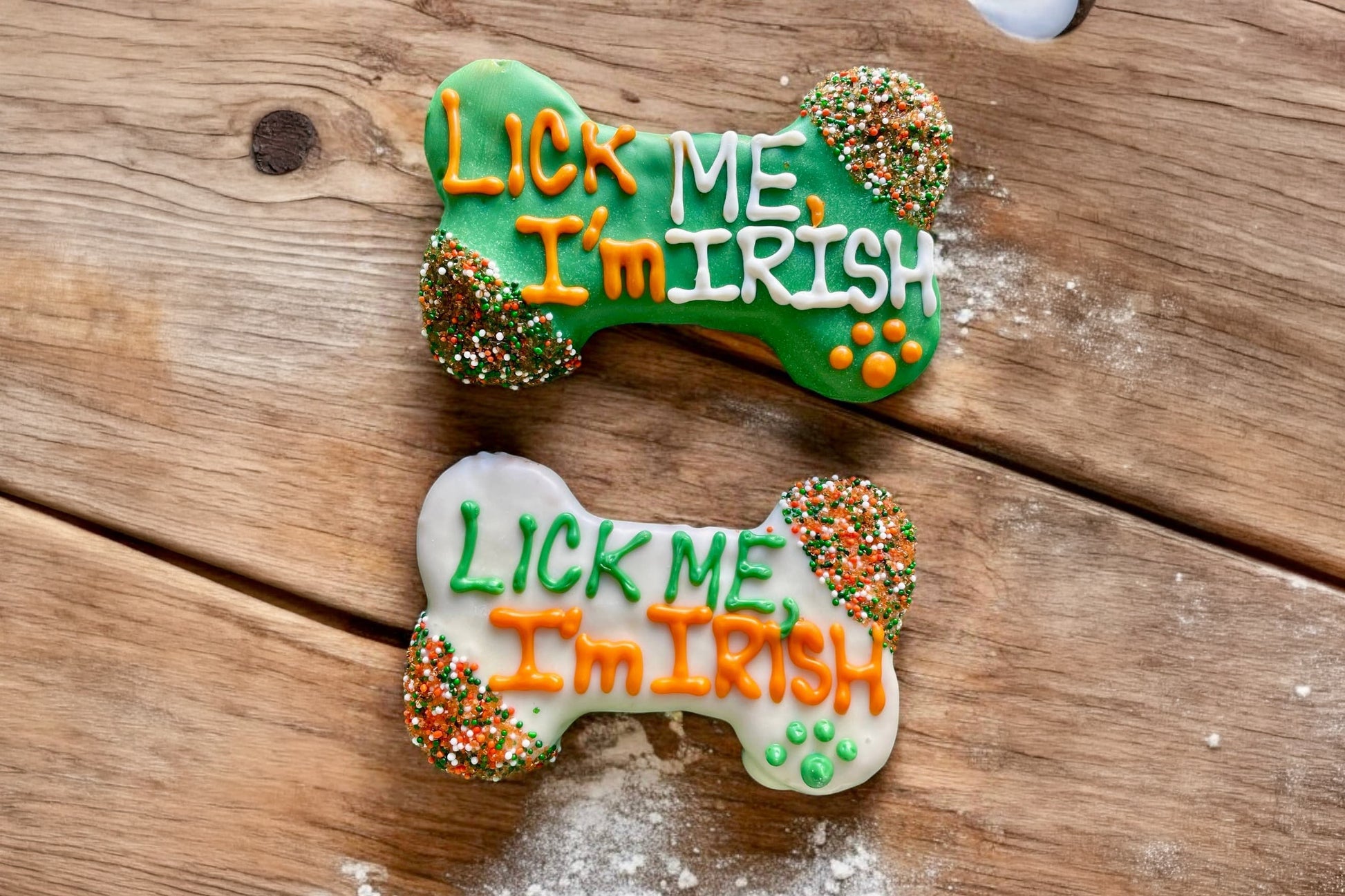 Two bone-shaped cookies for dogs with LICK ME, I'm IRISH text.