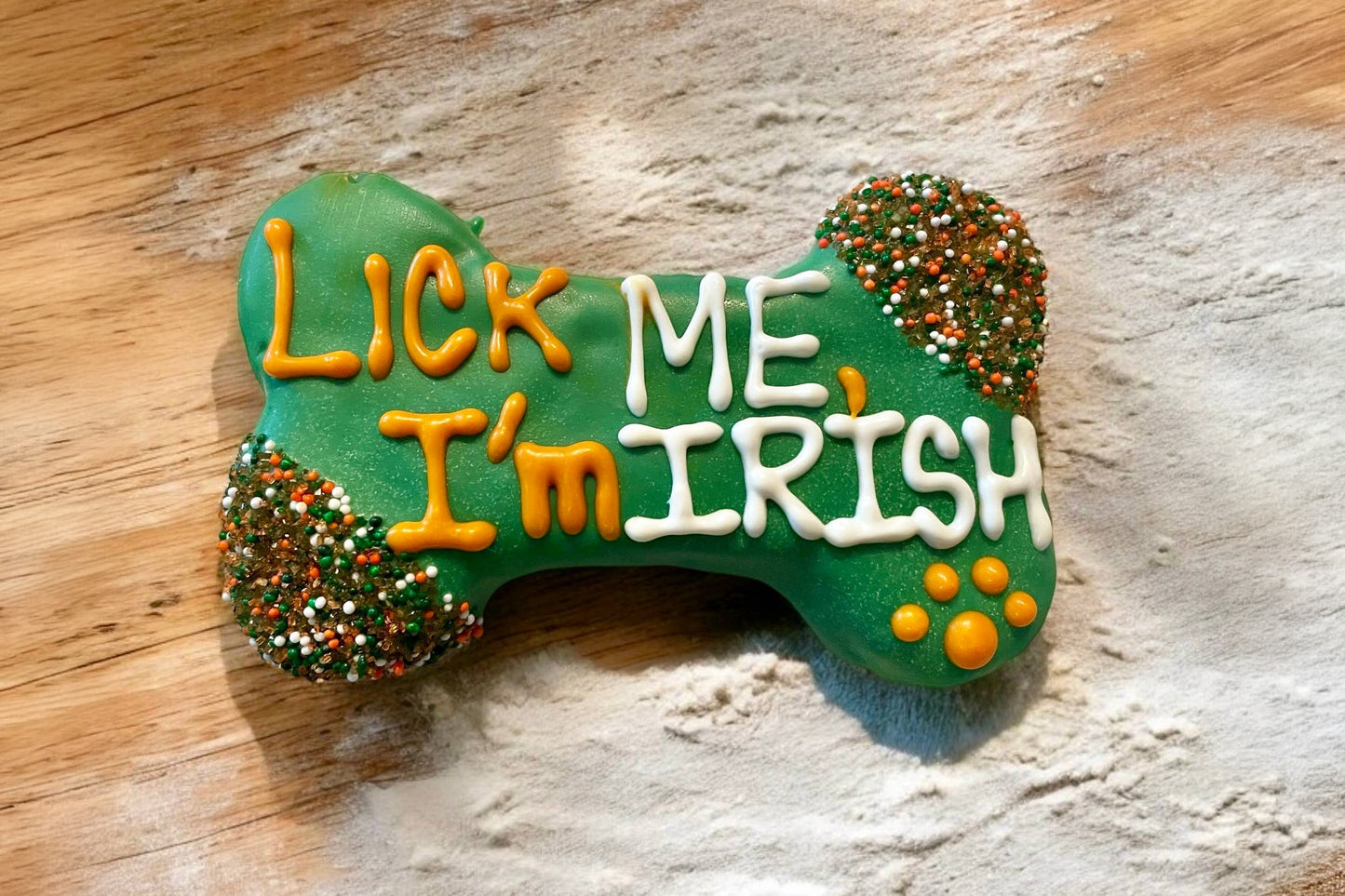 Green dog bone-shaped cookie with Lick Me, I'm Irish text.