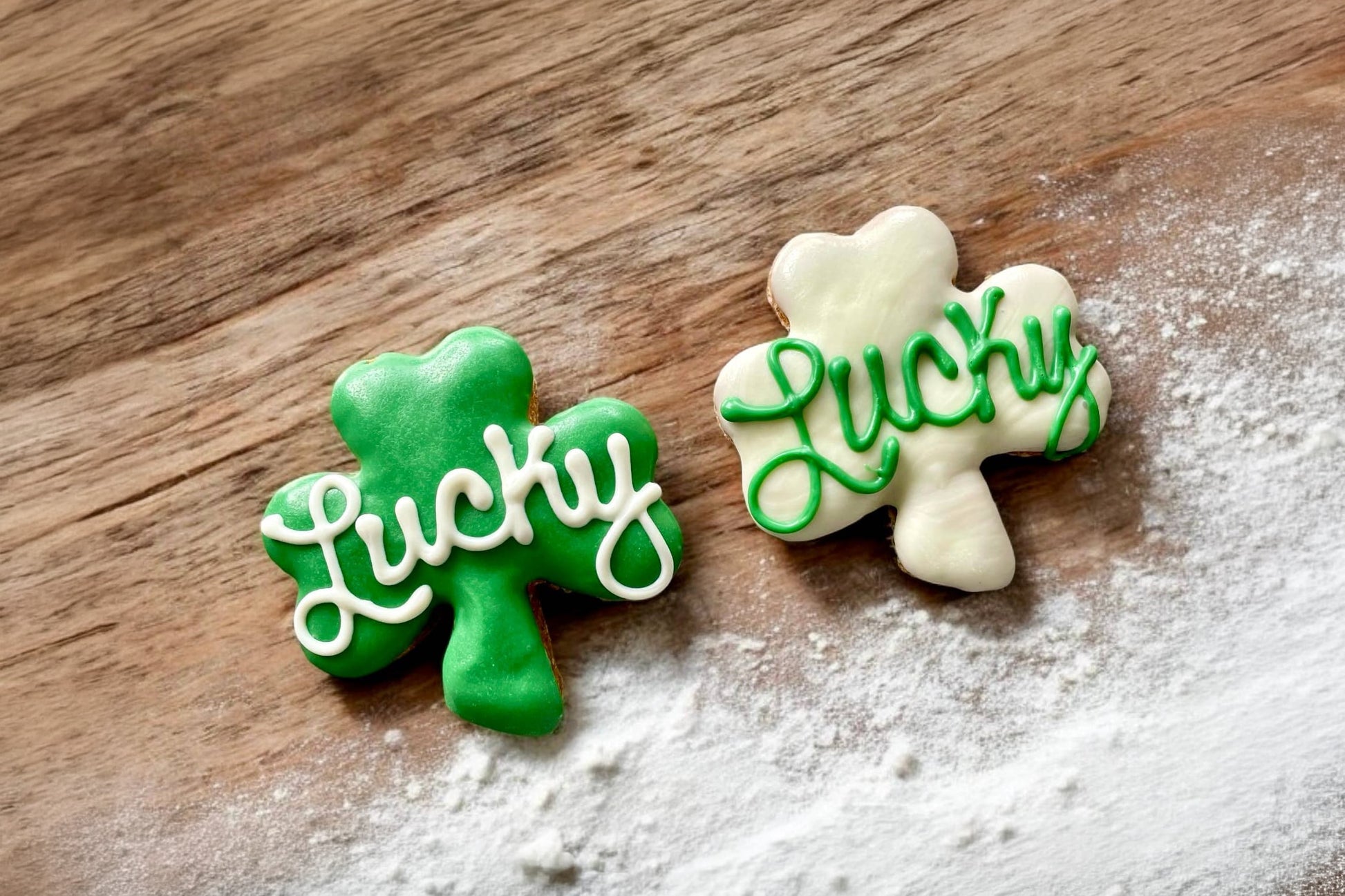 Two cookies for dogs shaped like shamrocks with Lucky text.